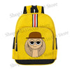 A yellow cartoon anime backpack featuring a round face with a brown hat and black trim.