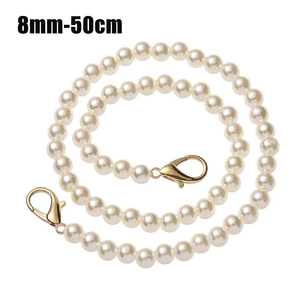 A strand of 8mm-50cm pearl beads used as a strap for a handbag or purse.