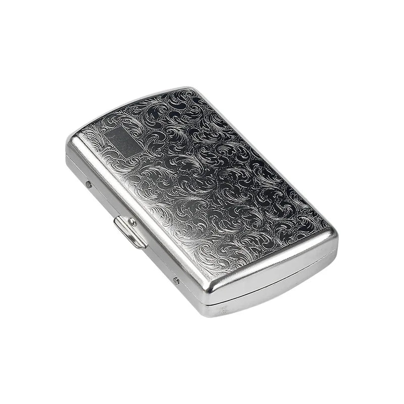 A rectangular, silver metal cigarette case with an ornate, swirling pattern on the lid.
