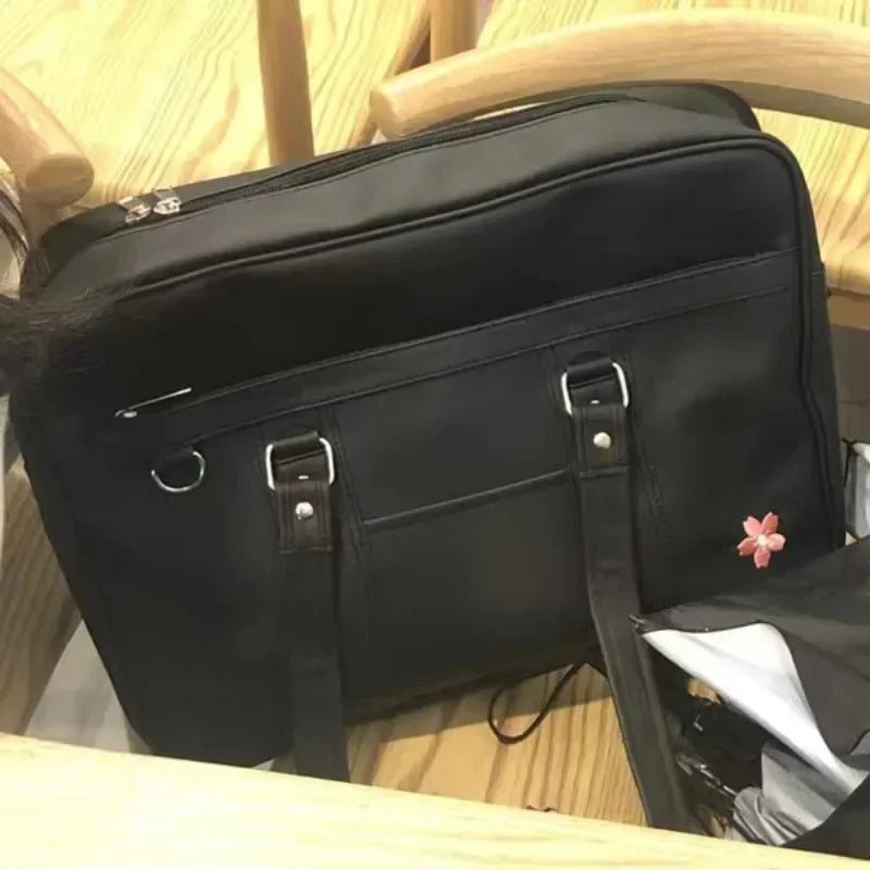 A black PU shoulder bag with a flap and strap is shown resting on a light wooden surface.