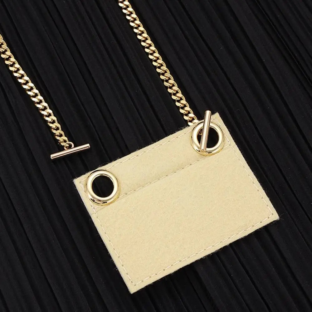 Gold chain strap attached to a beige tag, suitable for handbags and crossbody bags.