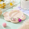 A light pink glow-in-the-dark pet collar for dogs and cats resting on a green surface.