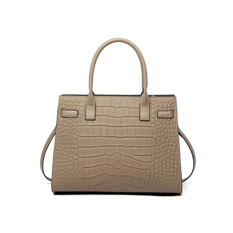 A beige genuine leather shoulder bag with a quilted texture and leather handles.