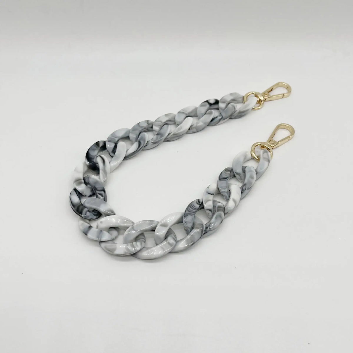 A silver and white multicolor acrylic chain bracelet with a twisted link design.