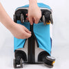 A hand is opening the protective cover of a suitcase, showing the blue fabric and wheels.