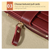 A close-up of a maroon PU leather card wallet with a gold-toned pull tag and visible zipper detail.