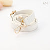 A roll of beige PU leather strap with a gold-toned clasp and hardware.