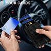 A hand holds a blue card near a black wallet inside a car interior, demonstrating quick access for cards.
