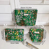 A set of elegant vintage cosmetic pouches in green fabric shown with various size options labeled L, M, and S.