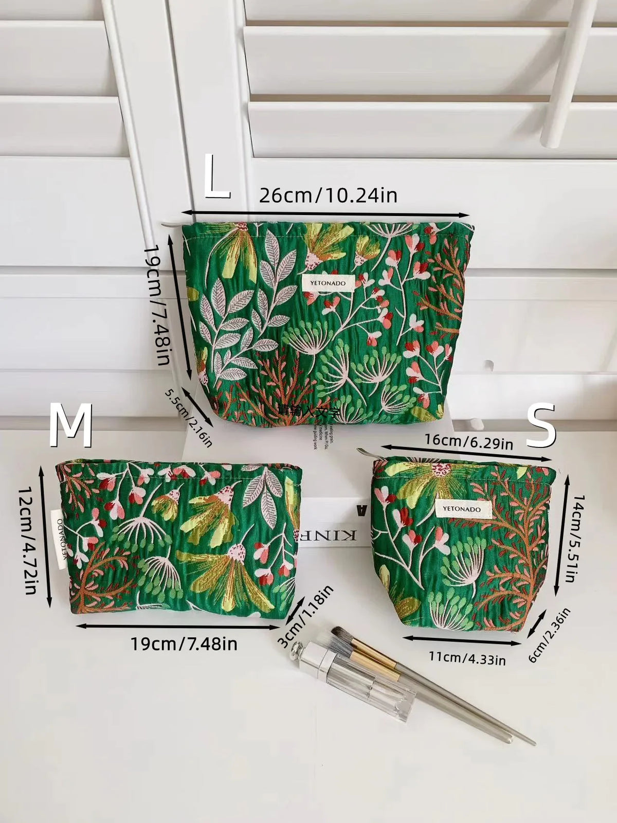A set of elegant vintage cosmetic pouches in green fabric shown with various size options labeled L, M, and S.