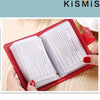 A red leather card holder with a clear plastic sleeve displaying precautions inside.
