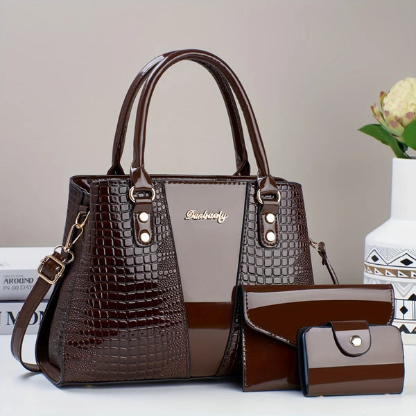 A dark brown crocodile pattern patent leather handbag and clutch set displayed on a white surface.