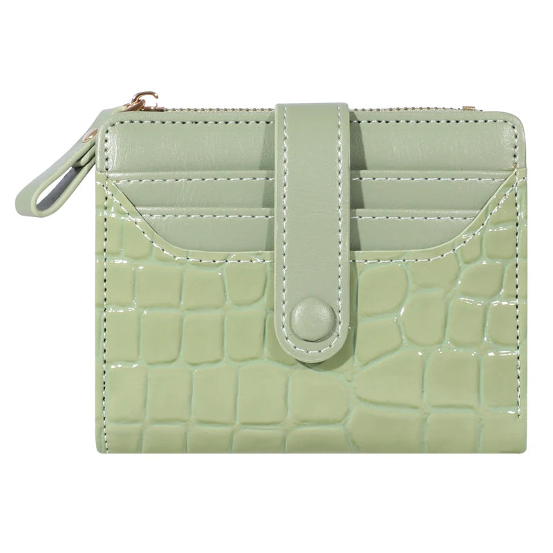 A light green PU leather card wallet with a crocodile texture and a flap closure.
