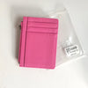 A pink genuine leather zipper card holder and coin purse packaged in a clear plastic bag.