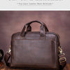 A dark brown genuine leather men's briefcase with brass hardware resting on a wooden surface.