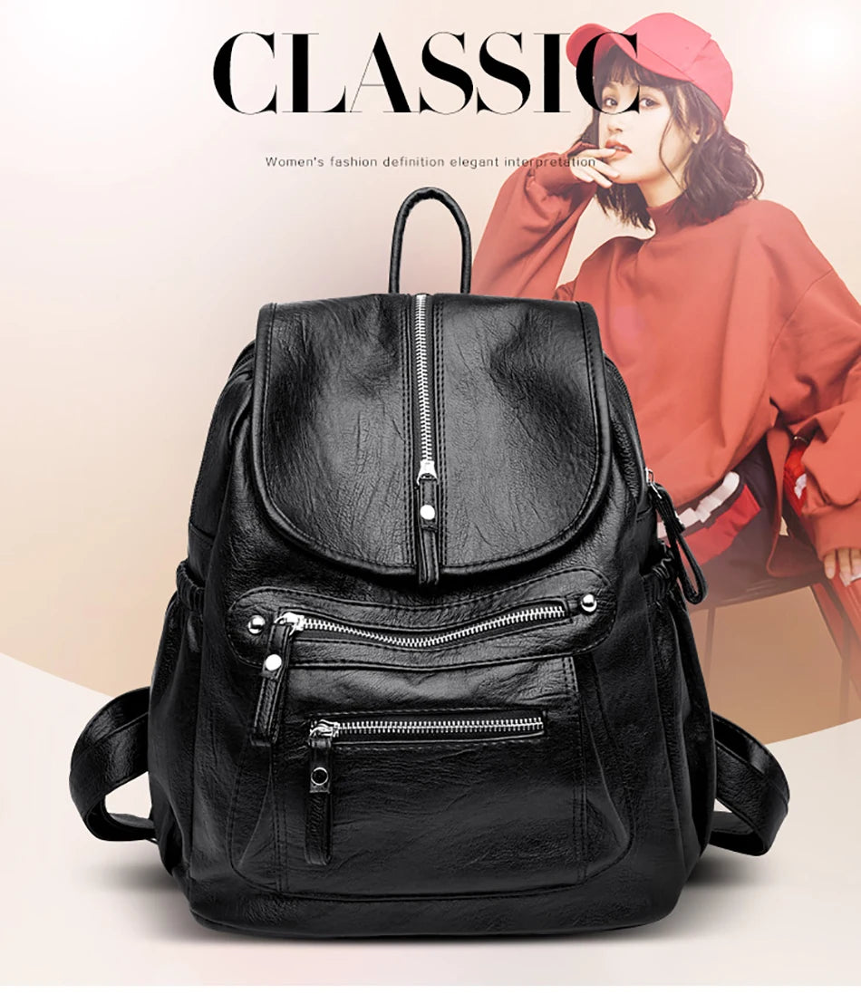 A black vintage soft leather backpack is shown against a light background with a woman in a red top in the background.