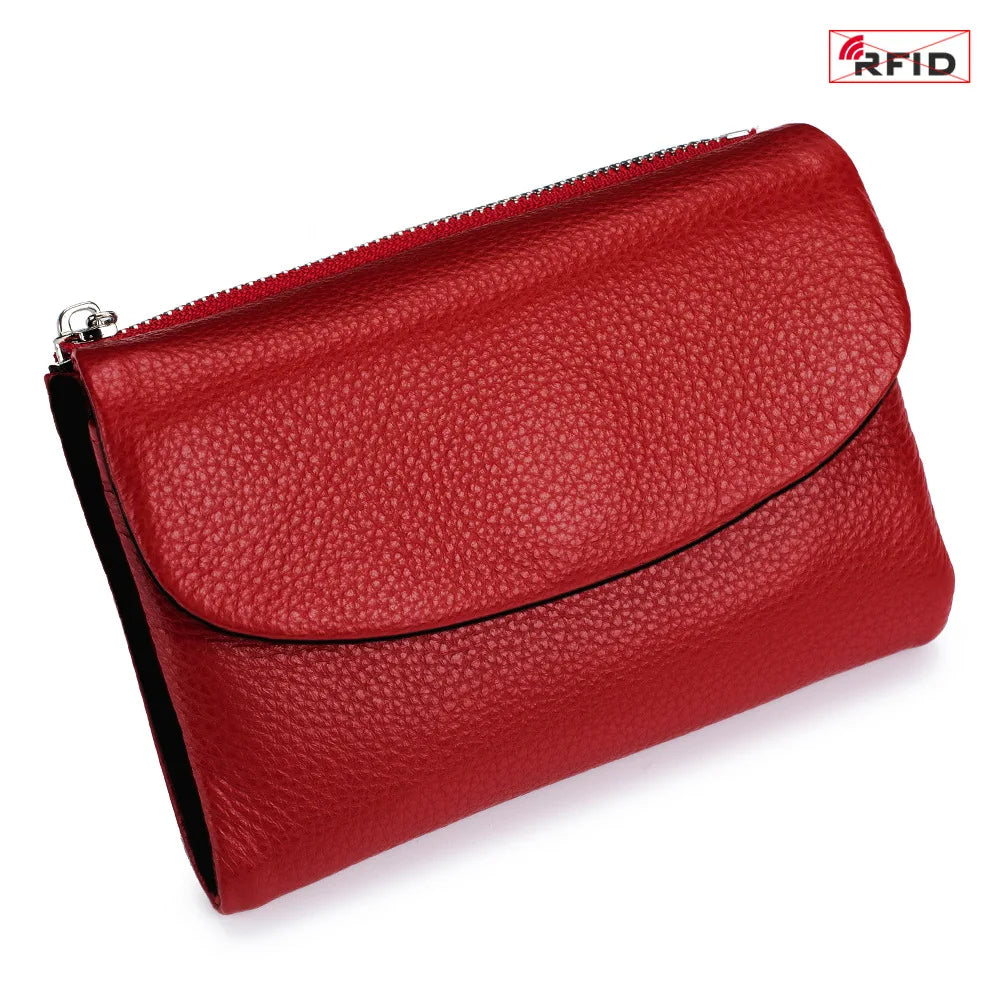 A red genuine leather mini card holder wallet with a zippered closure.