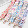 A set of adjustable diagonal shoulder straps in floral patterns for bags.