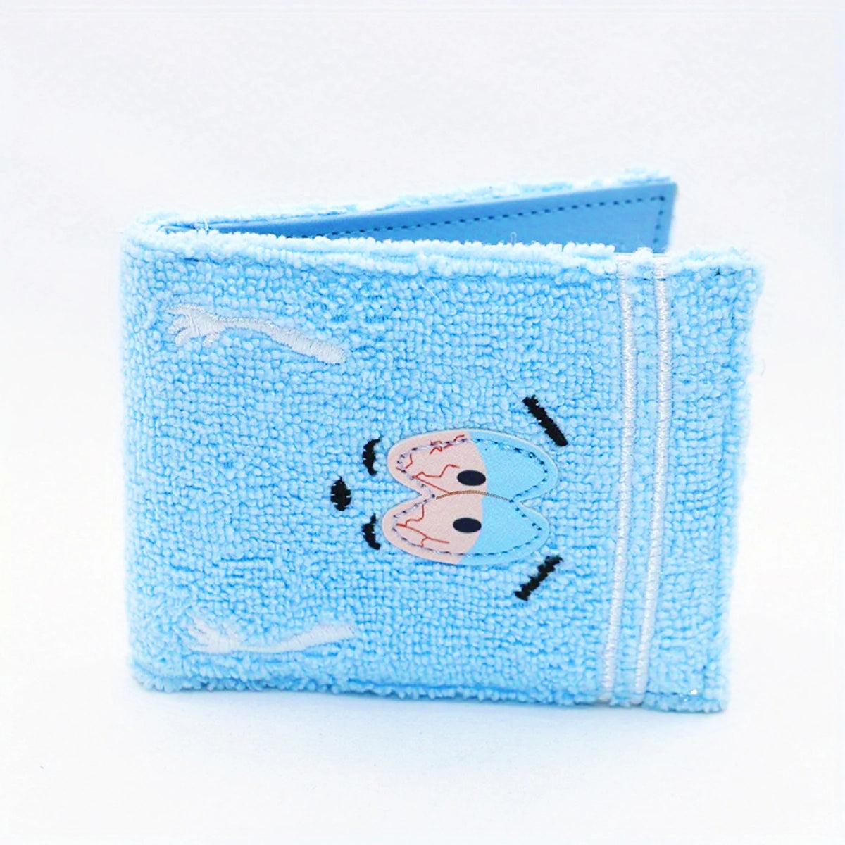 Light blue fabric wallet with embroidered cartoon eyes and a stitched edge.
