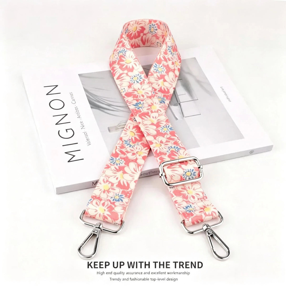 Pink floral patterned nylon crossbody bag strap with a silver metal buckle