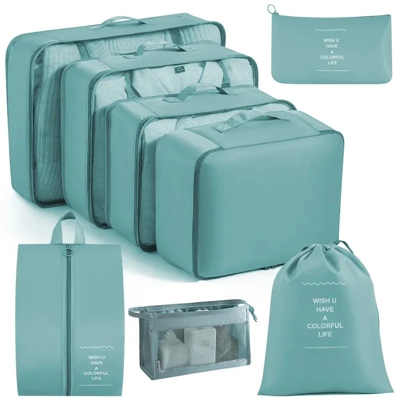 A set of teal mesh packing cubes and a matching drawstring bag for travel organization.