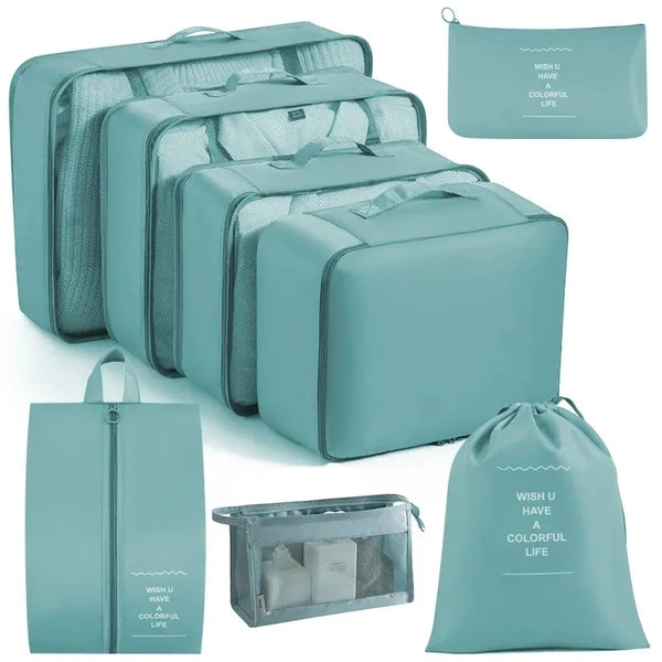 A set of teal mesh packing cubes and a matching drawstring bag for travel organization.