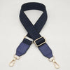 A dark blue braided nylon bag strap with gold-toned metal hooks.