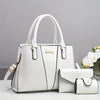 Un set de bolso de piel de cocodrilo de lujo blanco, con una tote grande y un clutch pequeño.