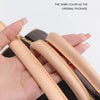A hand is holding a tan leather strap from a black bag, showing the color matches the original package.