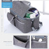 A gray reusable insulated lunch bag with an open pocket showing various items and a separate oblique plug bag.