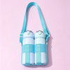 A light blue crossbody sling water bottle bag with a teal strap and matching bottles against a pink background.