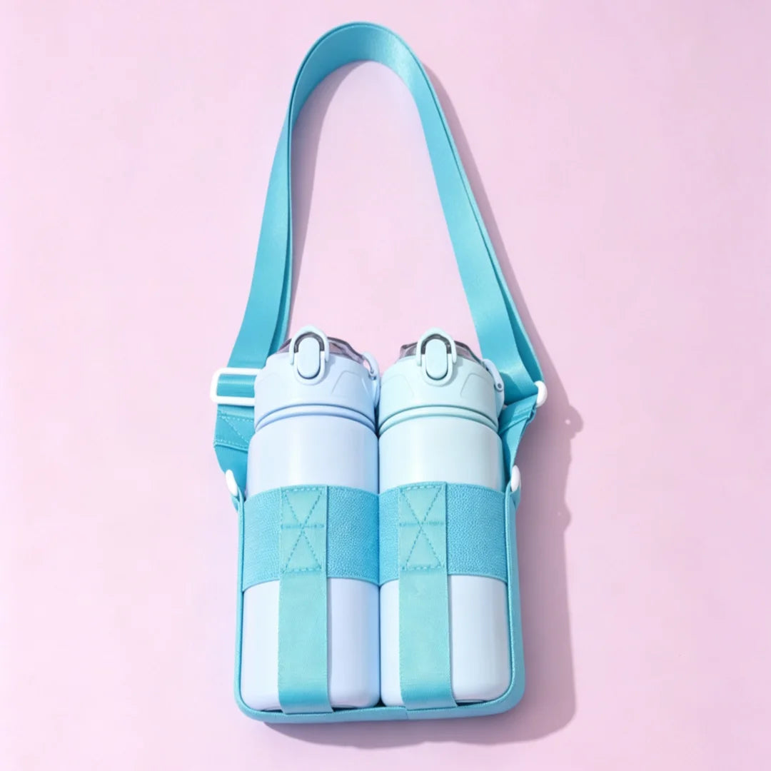 A light blue crossbody sling water bottle bag with a teal strap and matching bottles against a pink background.