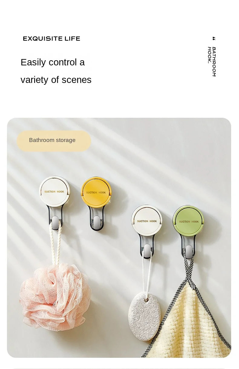 A set of translucent suction cup hooks used for bathroom storage, featuring pink and beige fabric items.