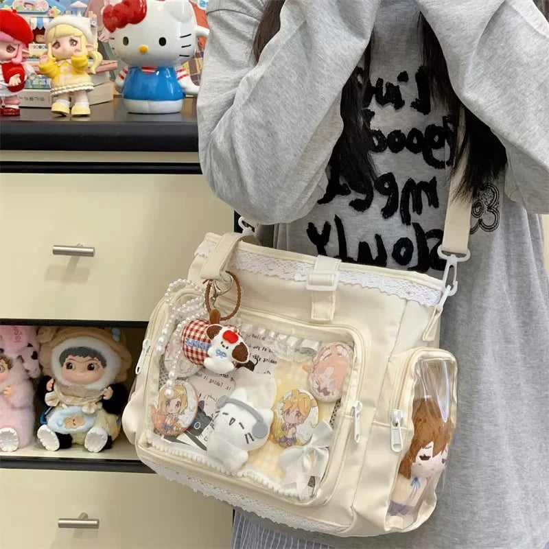A light beige transparent shoulder tote bag filled with various cute and aesthetic charms and accessories.