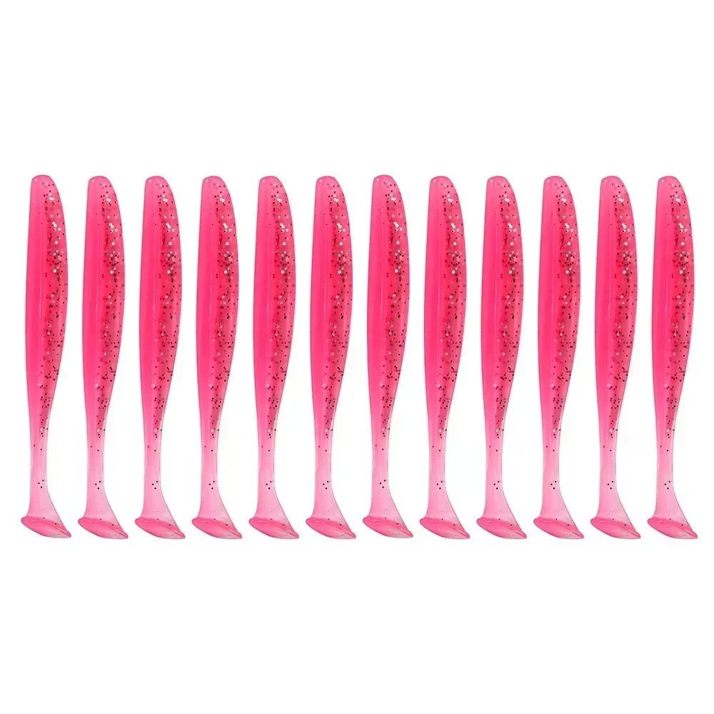 A row of pink, glittery soft lure fishing tackle baits.