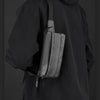A black hoodie features a black chest bag worn on the shoulder.