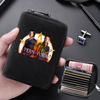 A black compact RFID-blocking card wallet with 11 slots is held in a hand, featuring a graphic of two men.