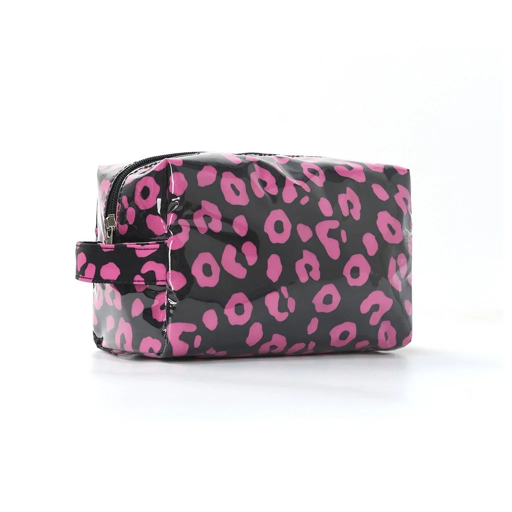A black cosmetic bag with a pink leopard print pattern.