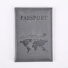 A dark gray leather passport holder with the word PASSPORT embossed and a world map design.