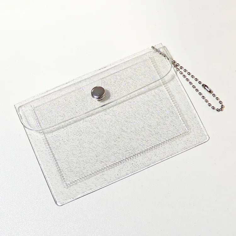 Clear acrylic card holder wallet with a silver charm and a chain attached