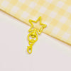 A yellow metal keychain clasp set featuring a five-pointed star shape.