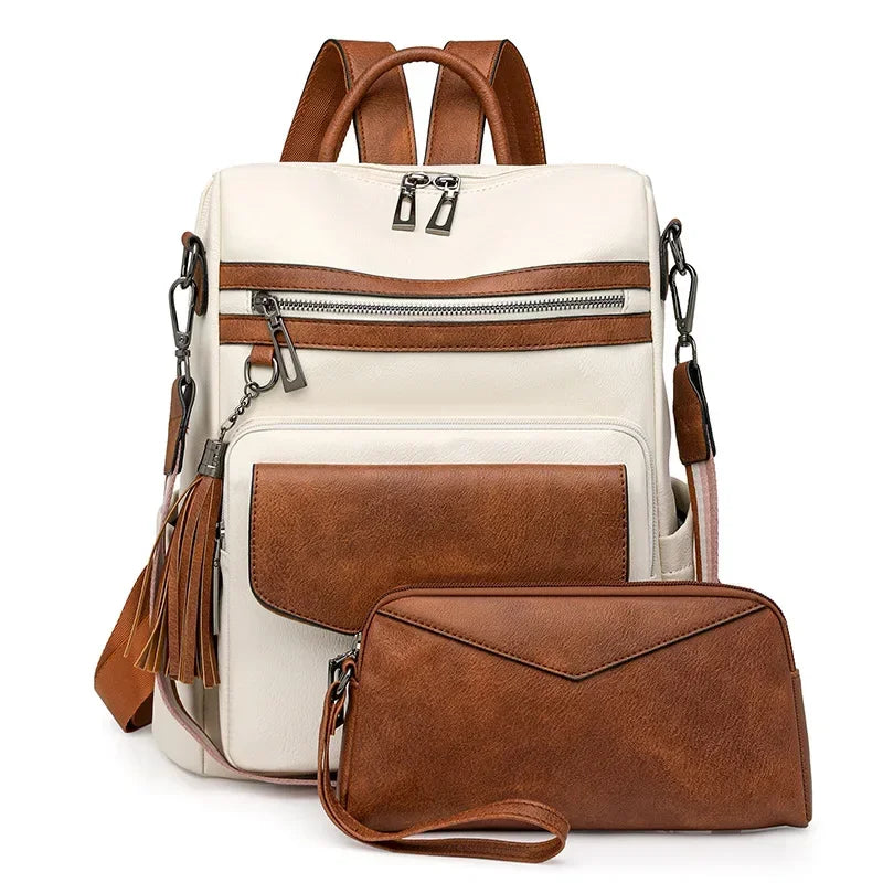 A cream-colored retro PU leather travel backpack with brown accents and tassel details.