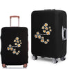 Black rolling suitcase with a floral design and a protective dust cover.