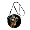 A black round crossbody bag featuring a cartoon cat and dog illustration.
