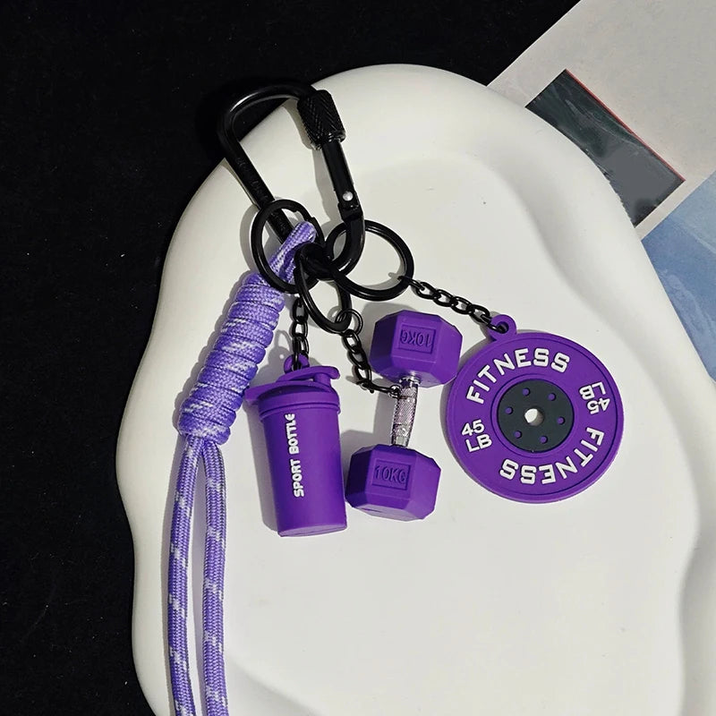 A purple nylon fitness keychain with a bottle attachment and a fitness disc is displayed on a white plate.