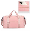 A pink large capacity travel duffle bag with a zipper and shoulder straps is shown next to a smartphone.