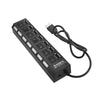 A black 7-port USB splitter hub with on/off switches and a cable.
