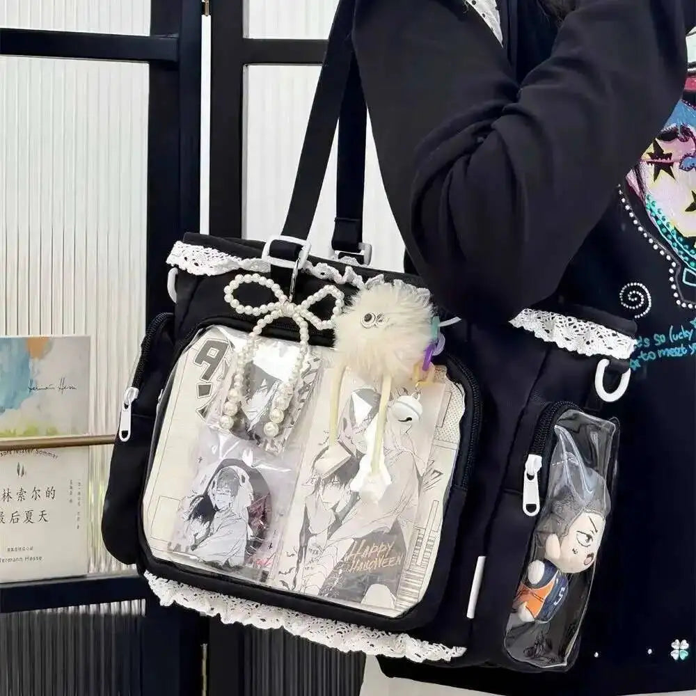 A black shoulder tote bag with a transparent front featuring various charms and designs.
