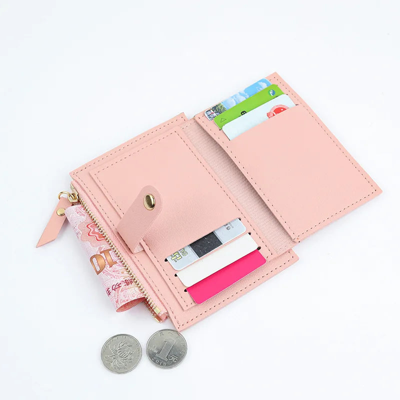 A pink PU leather mini card holder wallet with various cards and cash inside.