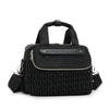 Black quilted mommy bag with a leather strap and gold hardware